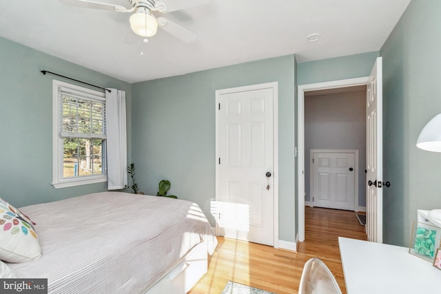 bedroom with light wood-type flooring and ceiling fan