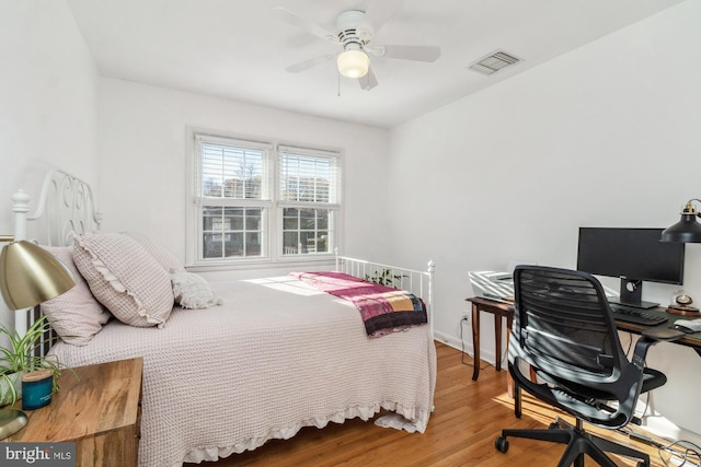 bedroom with hardwood / wood-style floors and ceiling fan