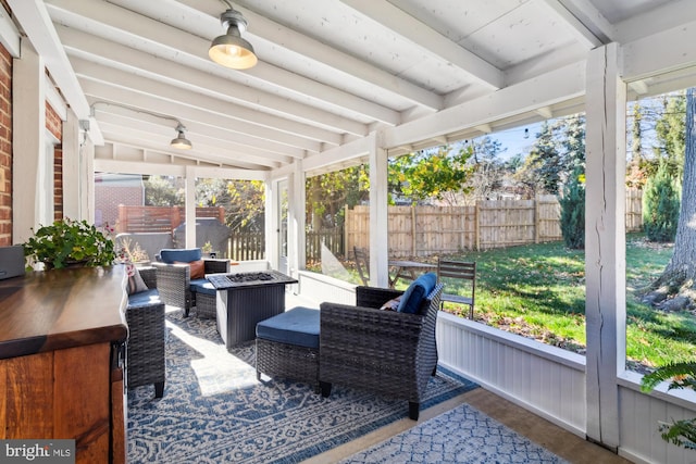 sunroom / solarium with a healthy amount of sunlight and lofted ceiling