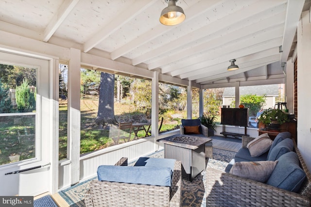 sunroom featuring lofted ceiling with beams