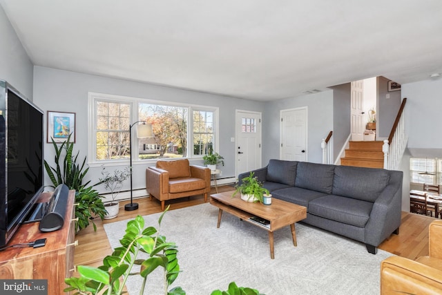 living room with plenty of natural light, light wood-type flooring, and baseboard heating