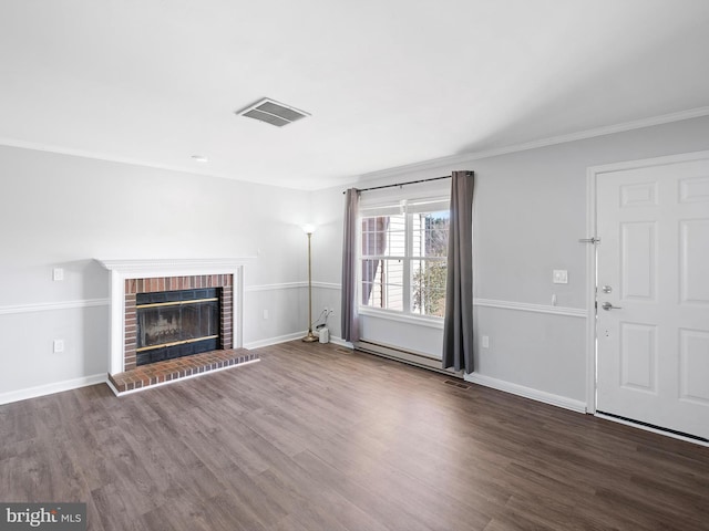 unfurnished living room featuring hardwood / wood-style flooring, ornamental molding, and a fireplace