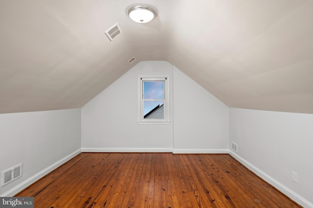 additional living space with lofted ceiling and wood-type flooring