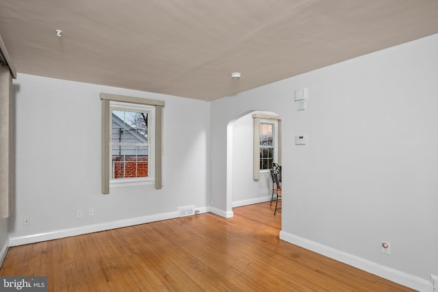 unfurnished room with light wood-type flooring