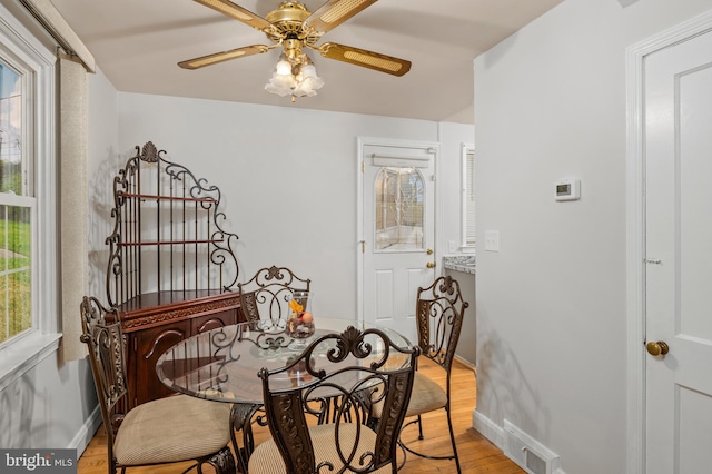 dining area with ceiling fan and light hardwood / wood-style floors