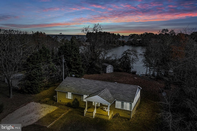 aerial view at dusk with a water view