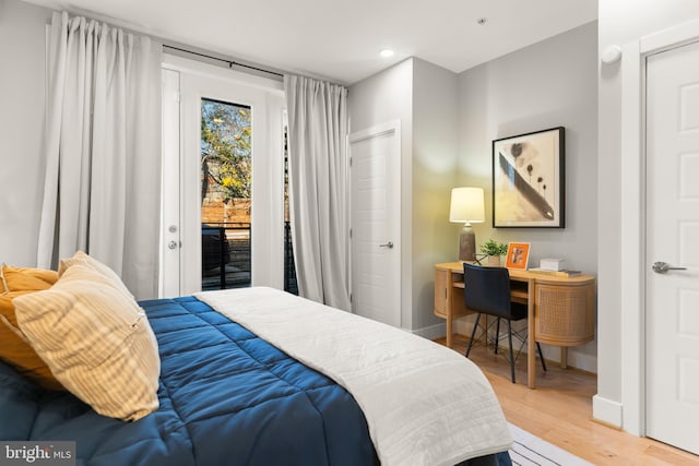 bedroom featuring access to outside and hardwood / wood-style flooring