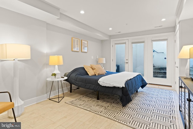 bedroom featuring access to outside, french doors, and light hardwood / wood-style floors