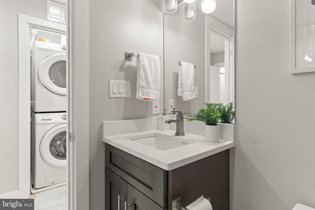 bathroom with stacked washer and dryer and vanity