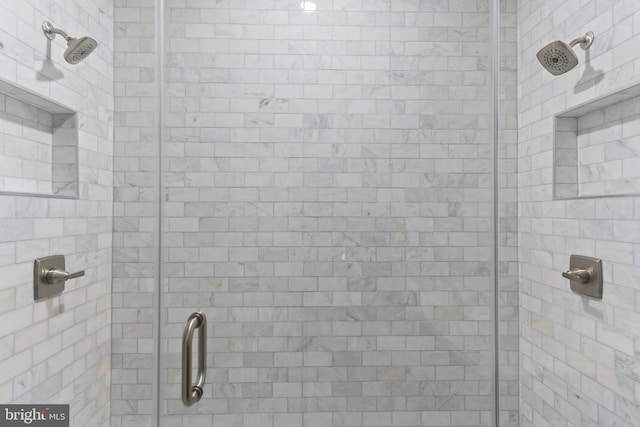 bathroom with a shower with door