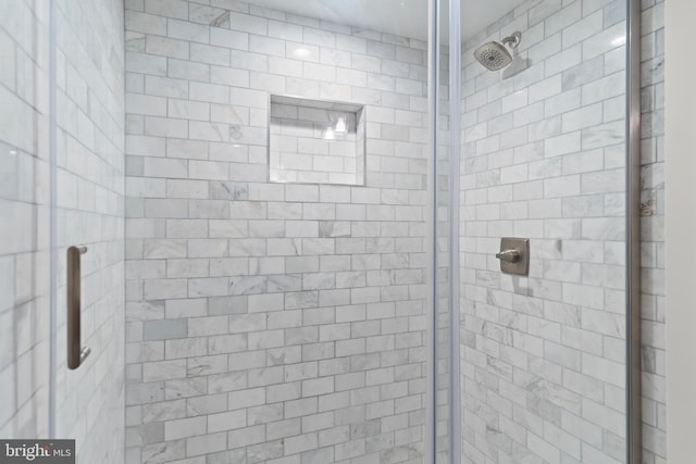 bathroom with a shower with door