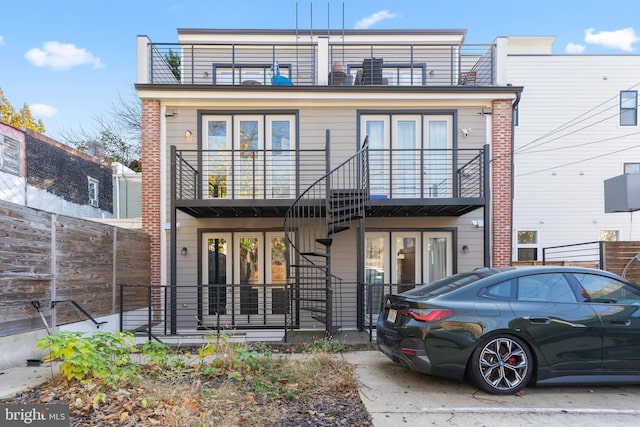 rear view of property with a balcony