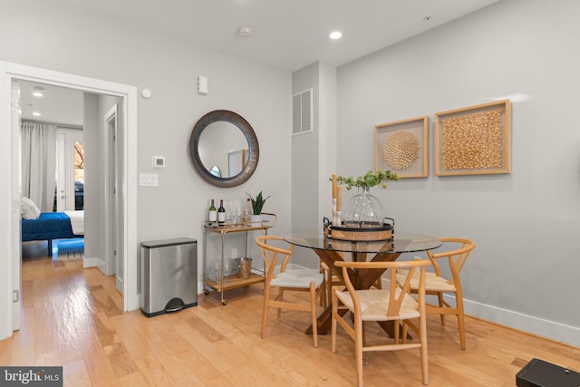 dining space featuring light wood-type flooring