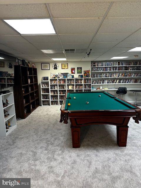 recreation room featuring carpet flooring and a paneled ceiling