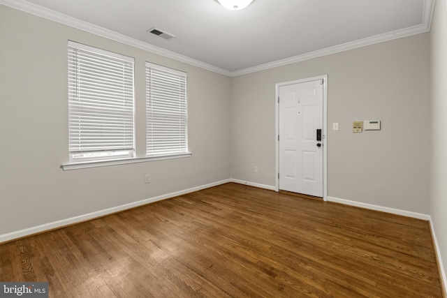 spare room featuring hardwood / wood-style floors and ornamental molding