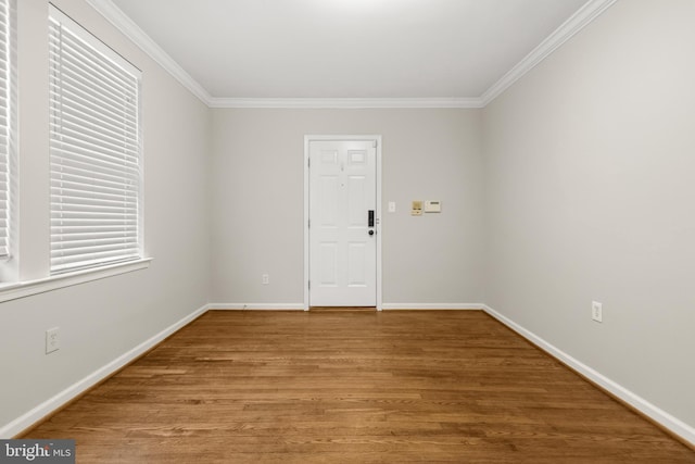 empty room featuring hardwood / wood-style floors and ornamental molding