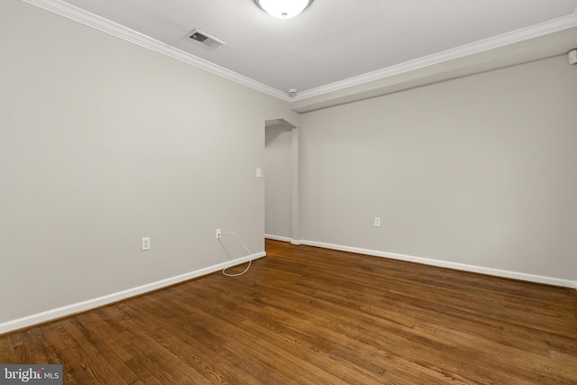 empty room with wood-type flooring and ornamental molding