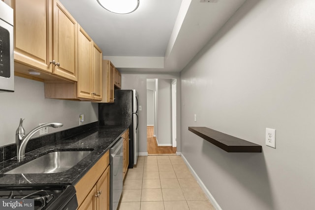 kitchen with black stove, stainless steel dishwasher, sink, dark stone countertops, and light tile patterned flooring