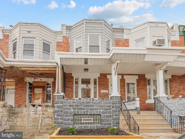 view of front of property featuring cooling unit and a porch