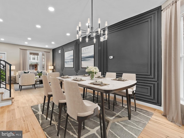 dining area with a chandelier and light wood-type flooring