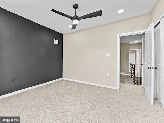 carpeted empty room featuring ceiling fan