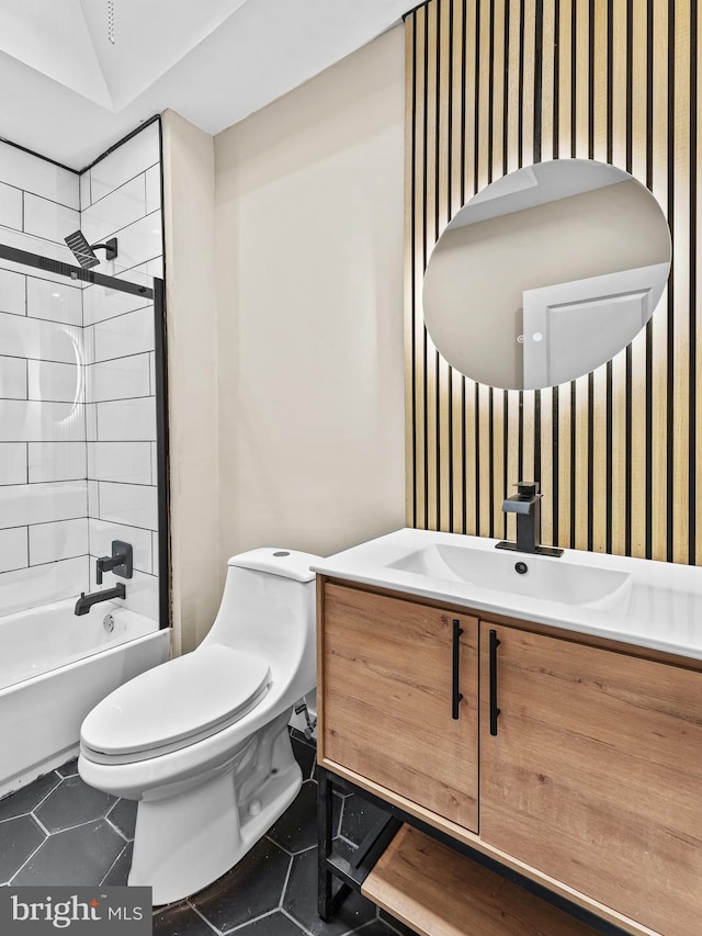 full bathroom featuring vanity, tile patterned floors, tiled shower / bath combo, and toilet