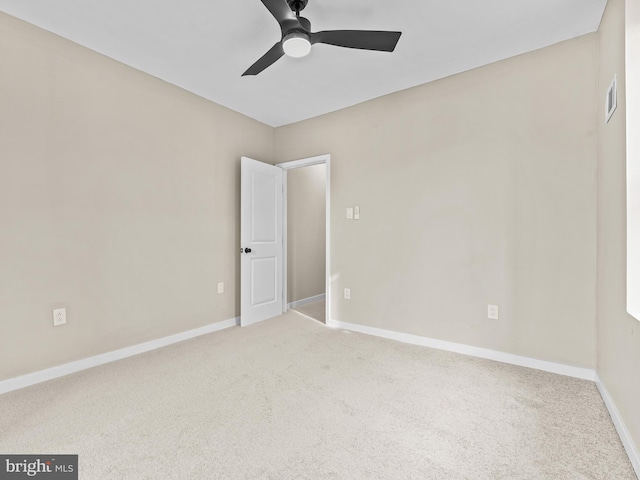 spare room featuring carpet and ceiling fan