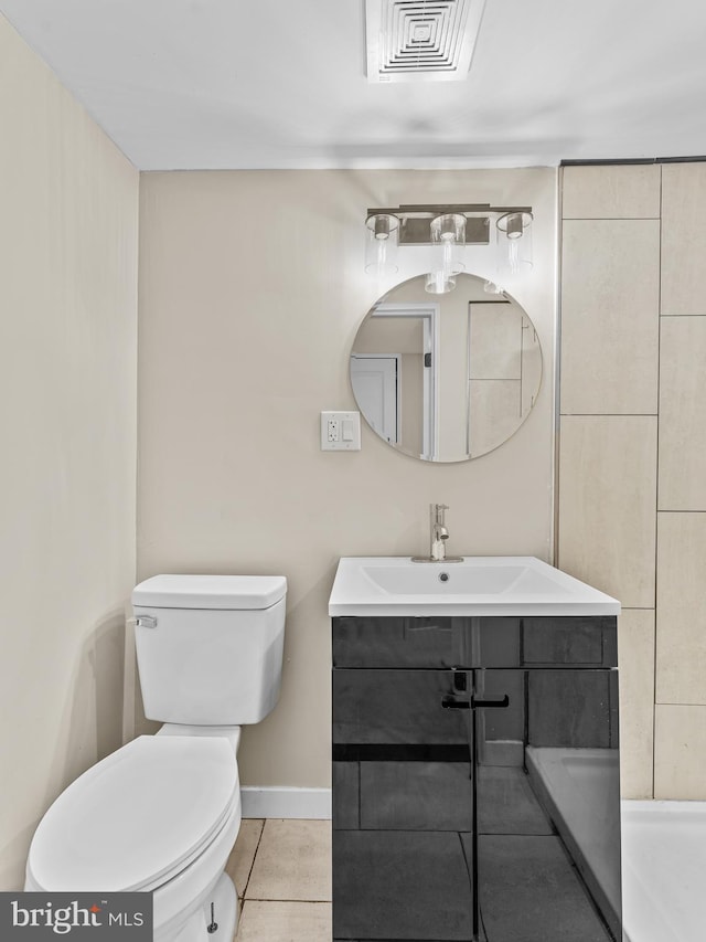 bathroom featuring tile patterned flooring, vanity, and toilet