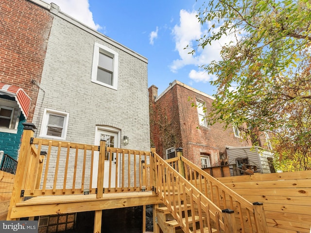 back of property featuring a wooden deck