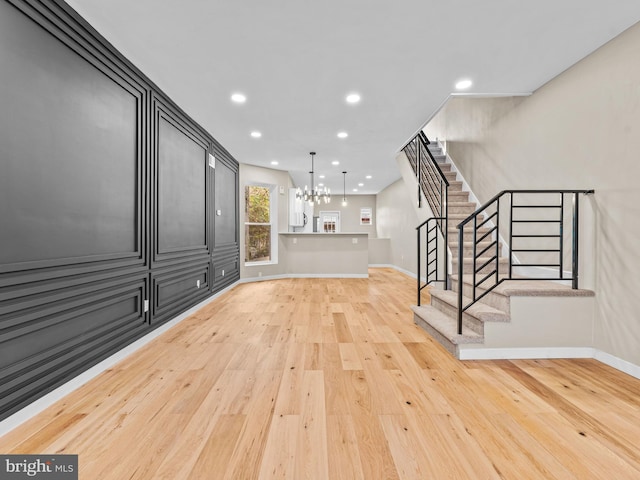 interior space with an inviting chandelier and light hardwood / wood-style flooring