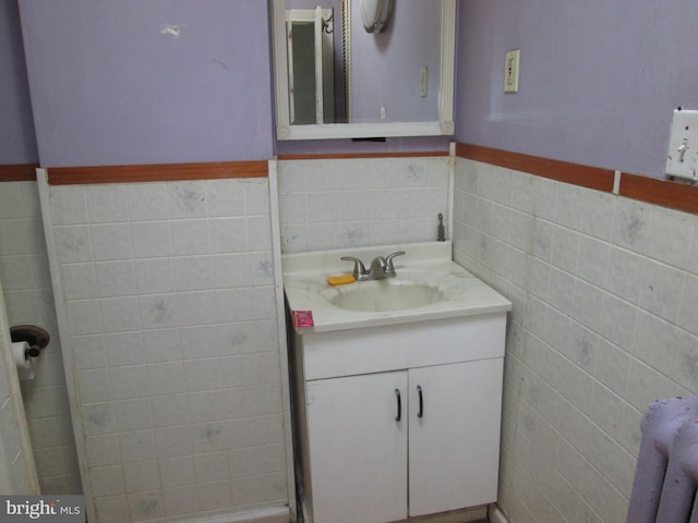 bathroom featuring vanity, tile walls, and radiator