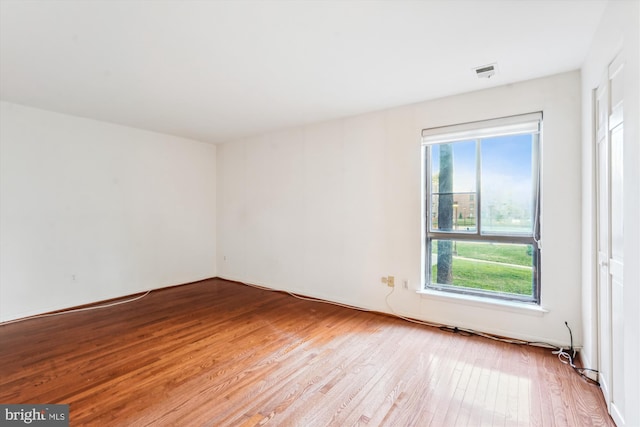 unfurnished room with a wealth of natural light and light hardwood / wood-style flooring