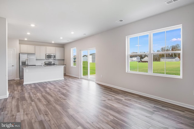 unfurnished living room with light hardwood / wood-style flooring