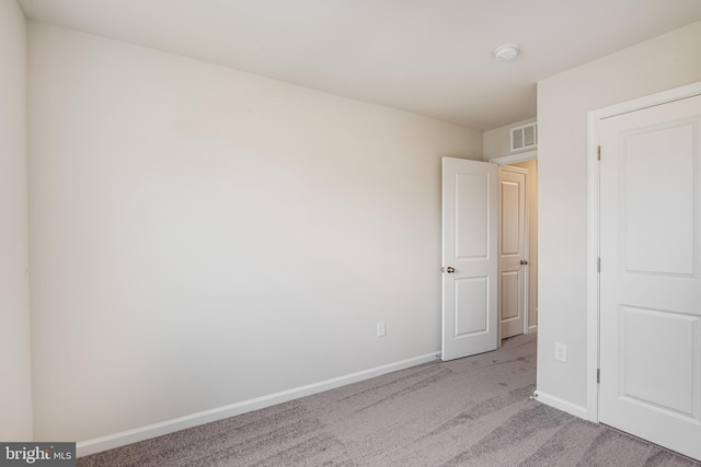 unfurnished bedroom featuring light carpet