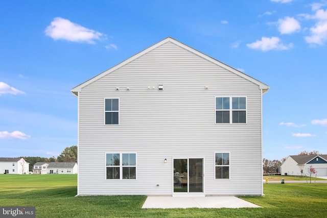 rear view of house featuring a lawn and a patio area