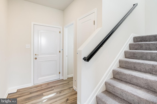 stairway featuring hardwood / wood-style flooring