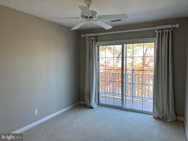 carpeted empty room featuring ceiling fan