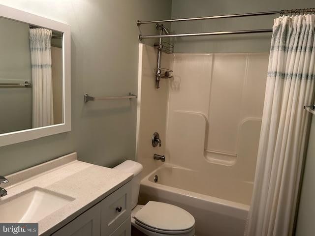 full bathroom with shower / bath combination with curtain, toilet, and vanity