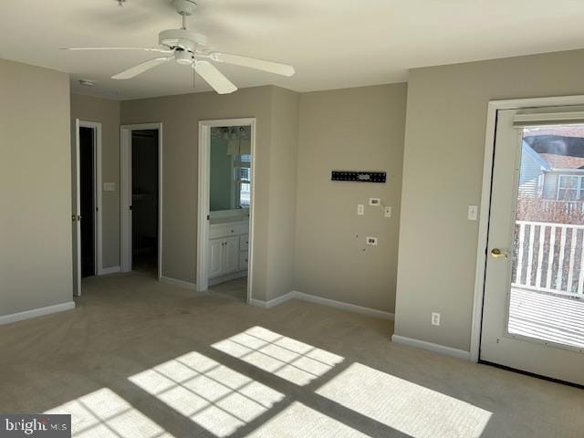 unfurnished bedroom with ceiling fan, light colored carpet, and ensuite bath