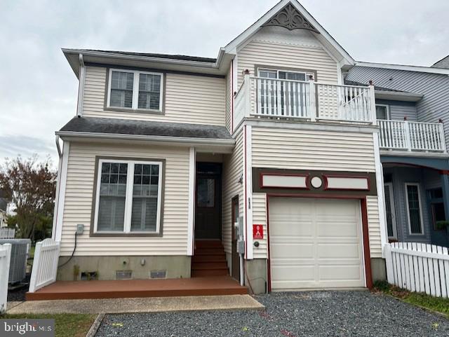 view of front of property with a balcony and a garage