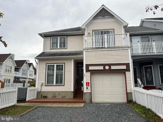 view of front facade featuring a balcony and a garage