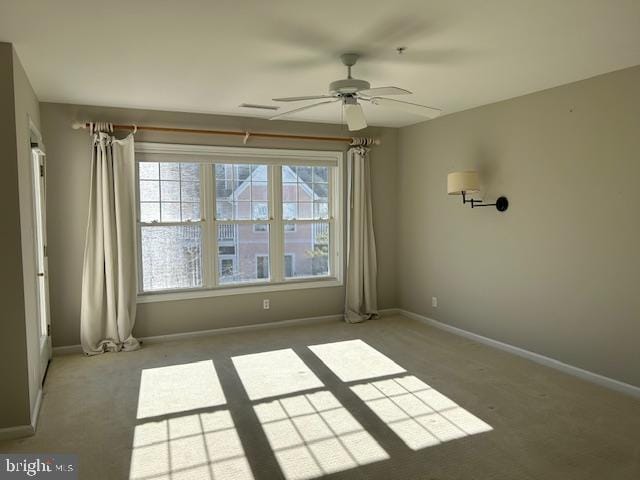 spare room featuring carpet flooring and ceiling fan