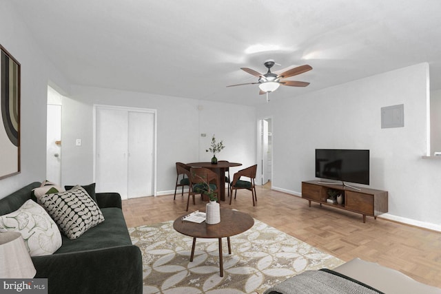 living room with ceiling fan and light parquet floors