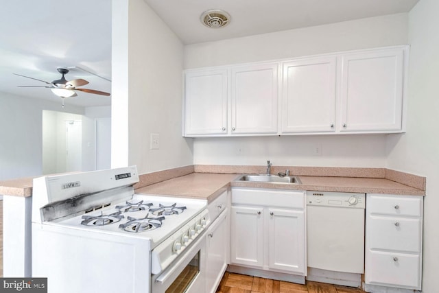 kitchen with kitchen peninsula, white appliances, ceiling fan, sink, and white cabinetry