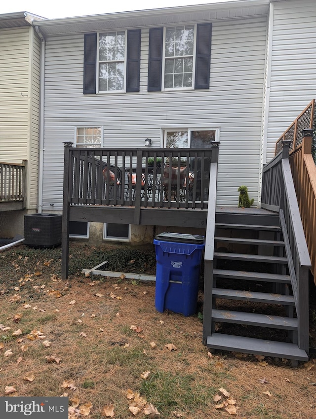 back of house with a deck and central AC