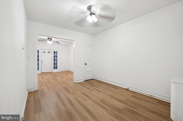 spare room featuring ceiling fan and light hardwood / wood-style floors