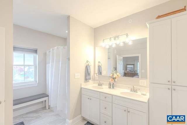 bathroom with a shower with shower curtain and vanity