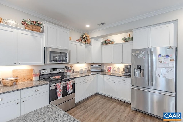 kitchen featuring white cabinets, light stone countertops, stainless steel appliances, and light hardwood / wood-style flooring