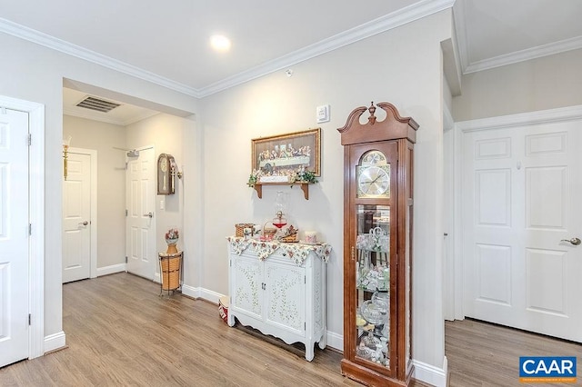 hallway featuring light hardwood / wood-style flooring and ornamental molding