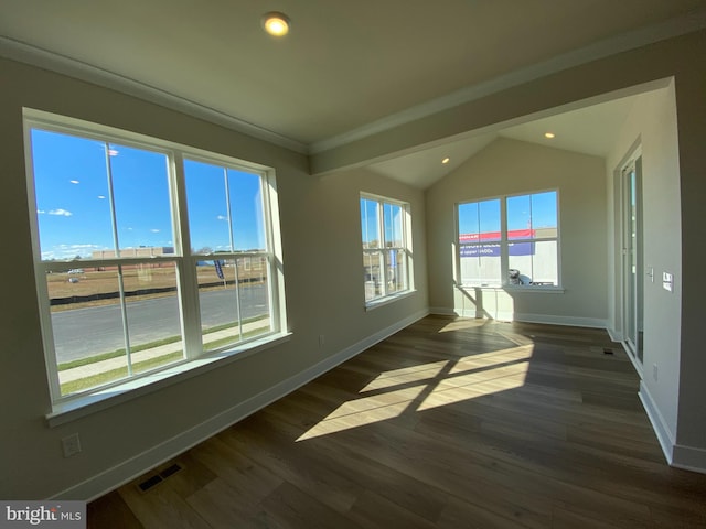 unfurnished room featuring lofted ceiling, crown molding, and dark hardwood / wood-style floors